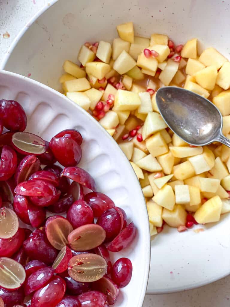 process s،t of adding fruit to dressing in bowl
