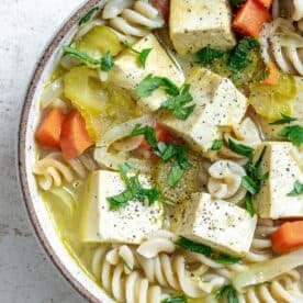 bowl of completed cooked soup on a white surface
