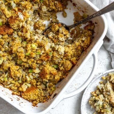 completed Easy Cornbread Stuffing in baking dish against a white background