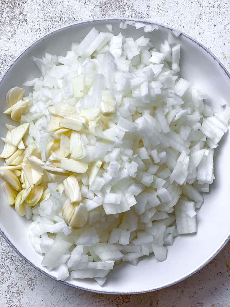 sliced onions and garlic on a plate