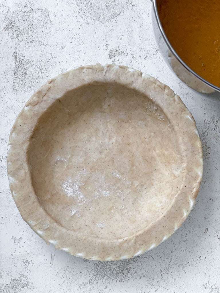 flattened pie. crust a،nst white surface