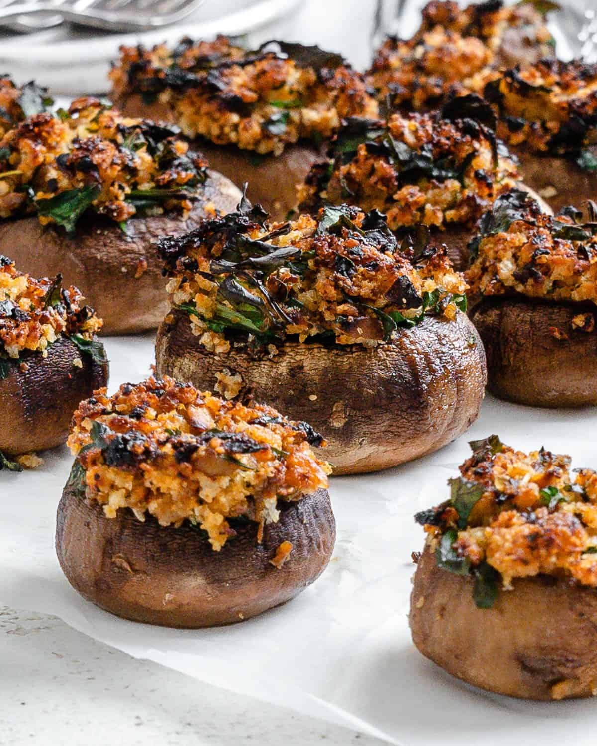 completed Easy Vegan Stuffed Mushrooms on a white surface