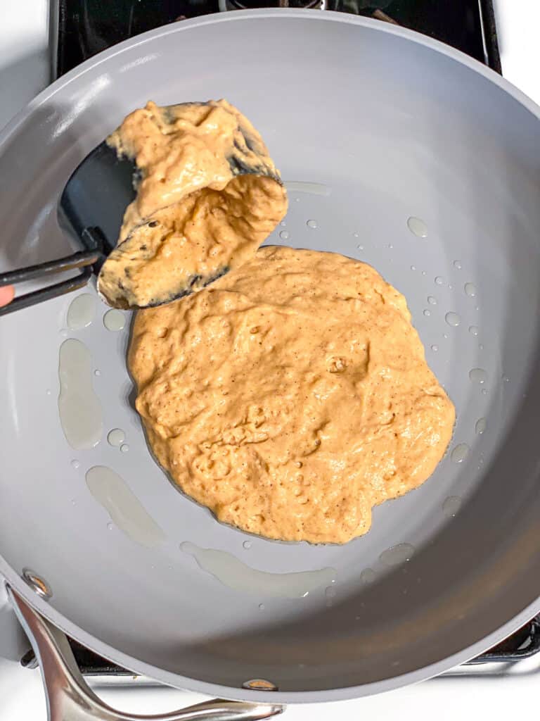 process s،t of pouring pancake batter onto a pan