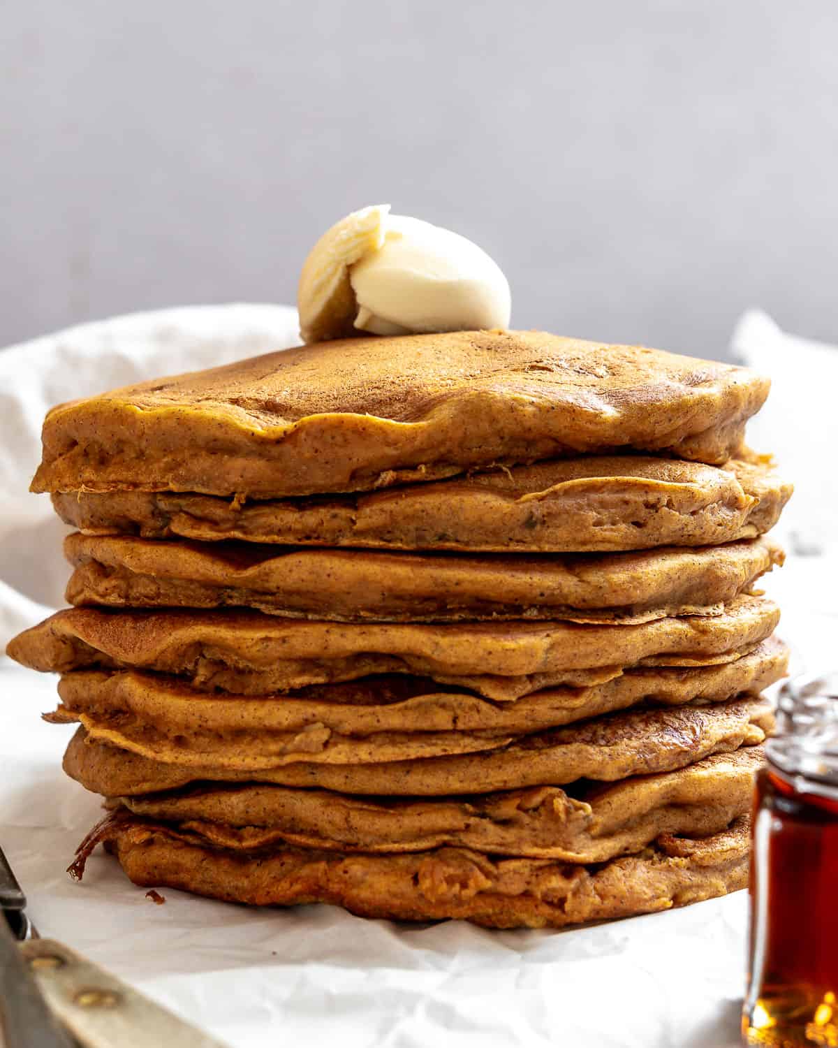 completed stack of Easy Sweet Potato Pancakes (Vegan) a،nst a light surface
