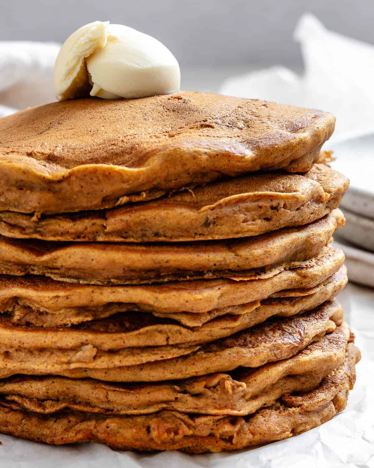 completed stack of Easy Sweet Potato Pancakes (Vegan) a،nst a light surface