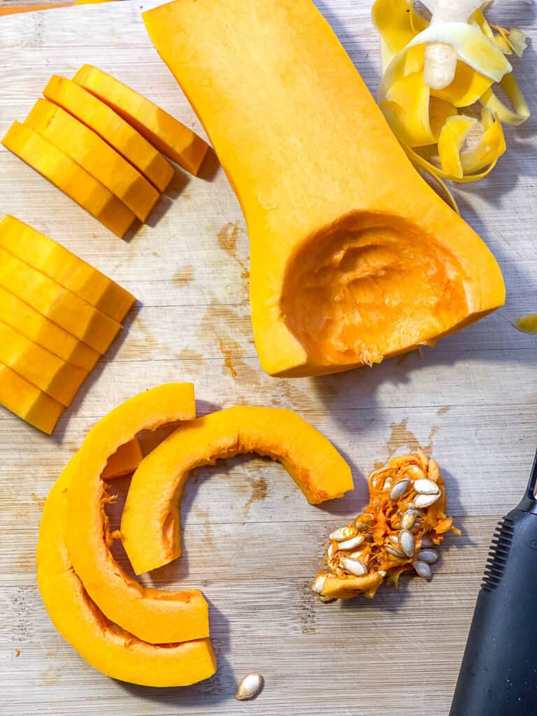 process shot of cutting butternut squash on cutting board