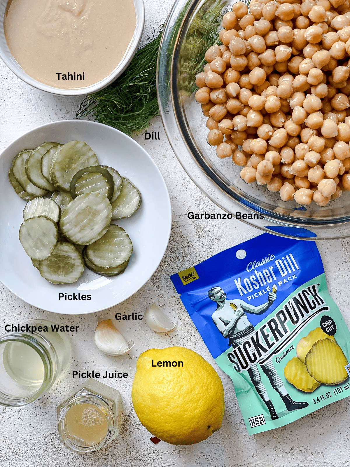 Ingredients for Dill Pickle Hummus measured out against a white surface.