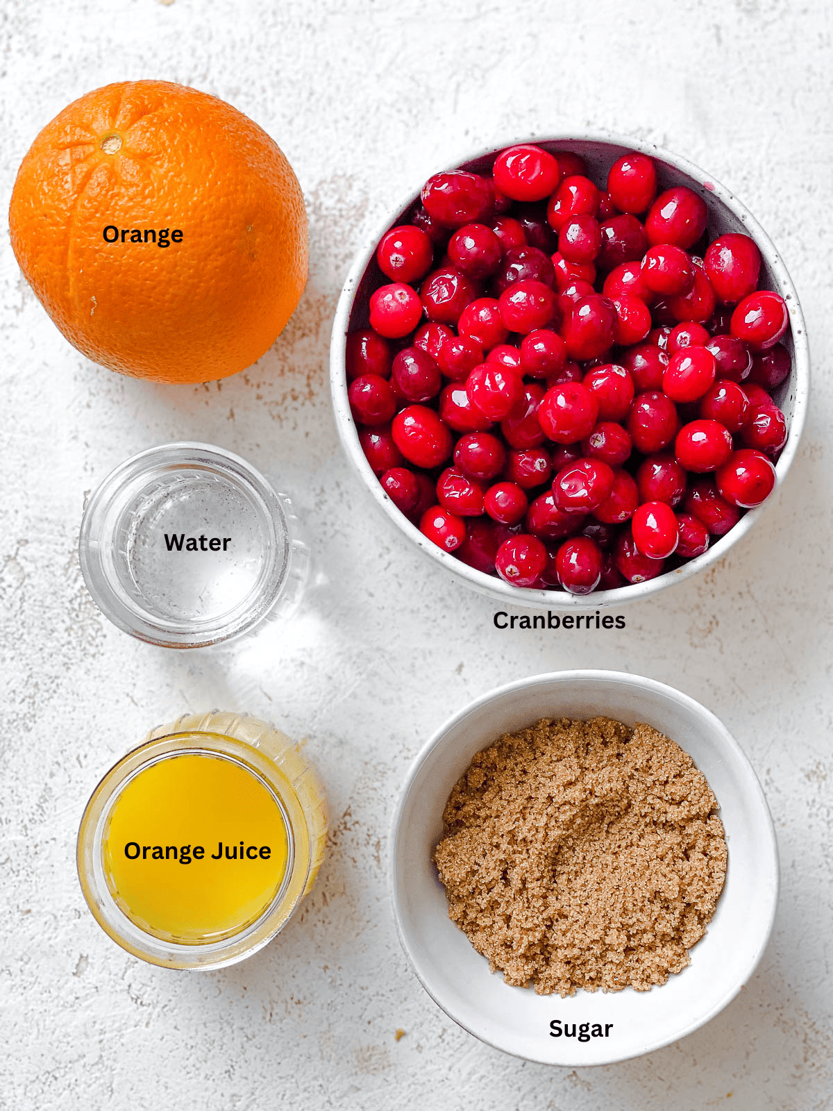ingredients for Easy Cranberry Sauce with Orange Juice on a white surface