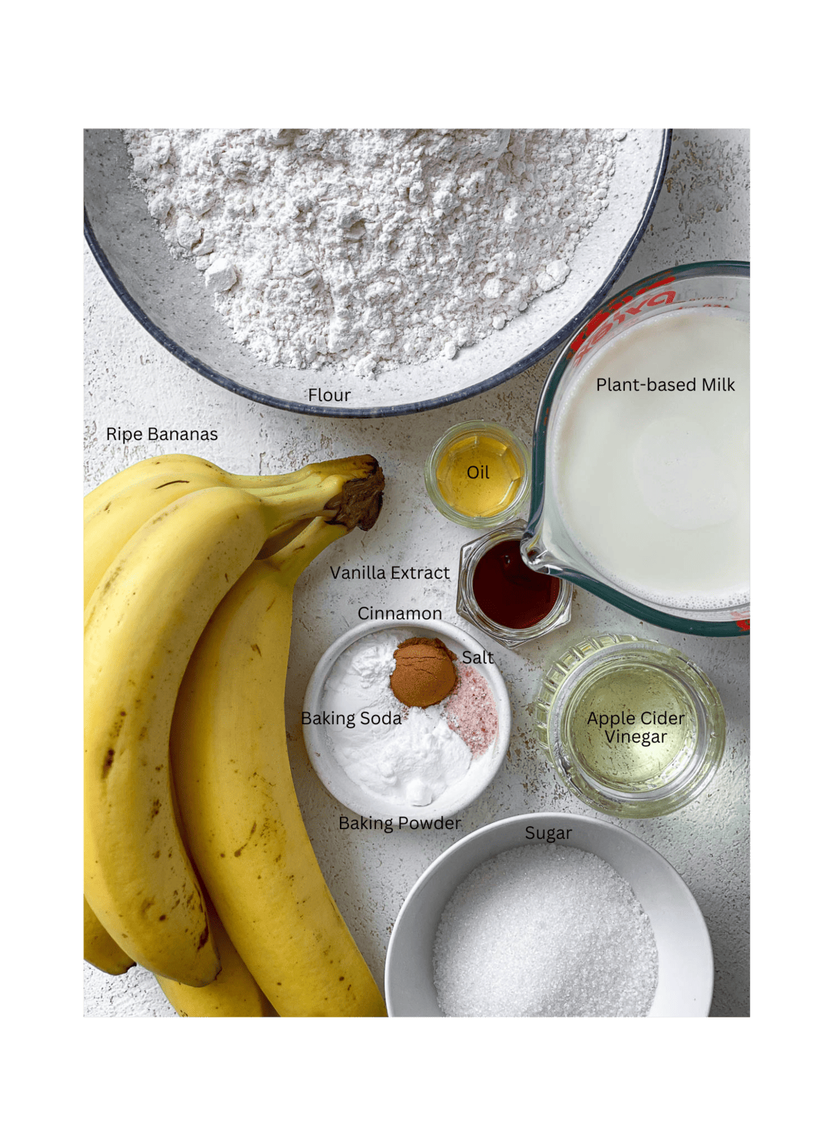 ingredients for Easy Vegan Banana Cake measured out on a white surface