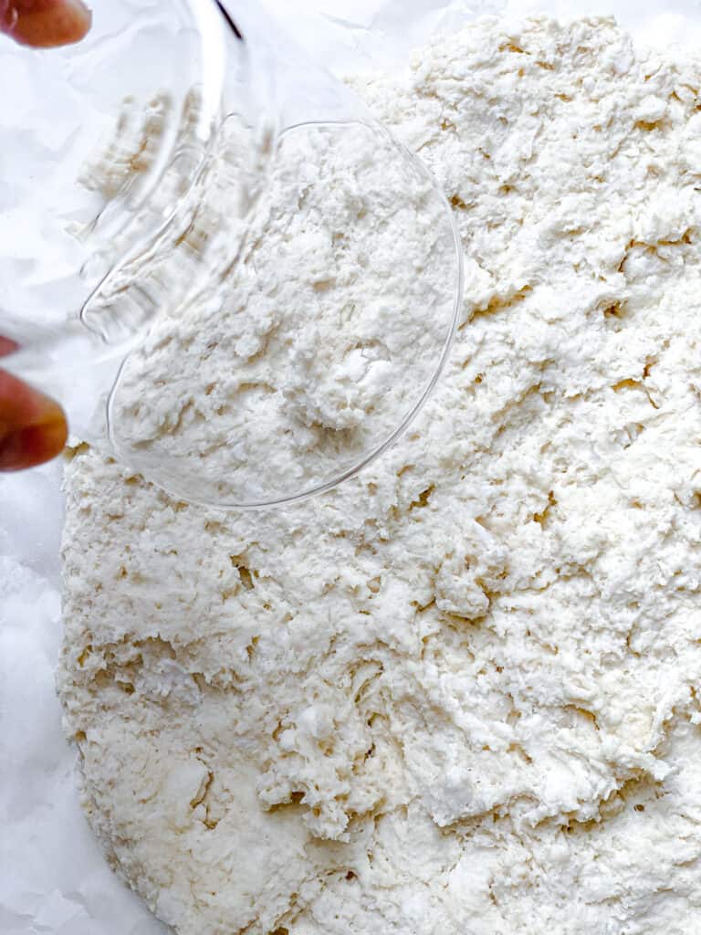 dough spread out on a white surface