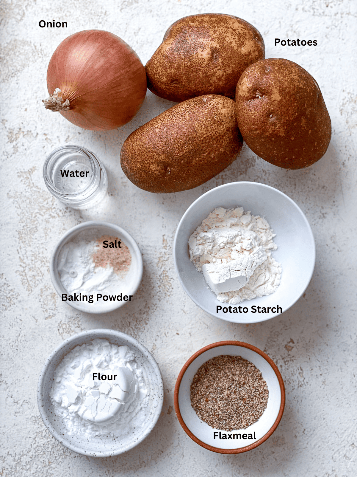 ingredients for Vegan Potato Latkes on a white surface