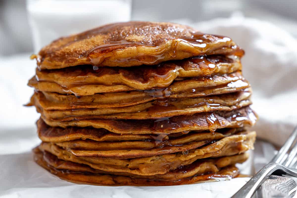 completed Easy Vegan Pumpkin Pancakes on a white surface