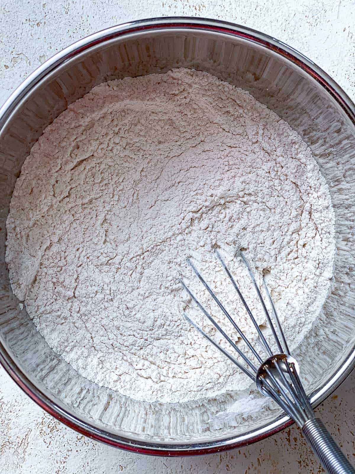 Flour, cream of tartar, baking soda, cinnamon, and salt whisked together in a bowl.