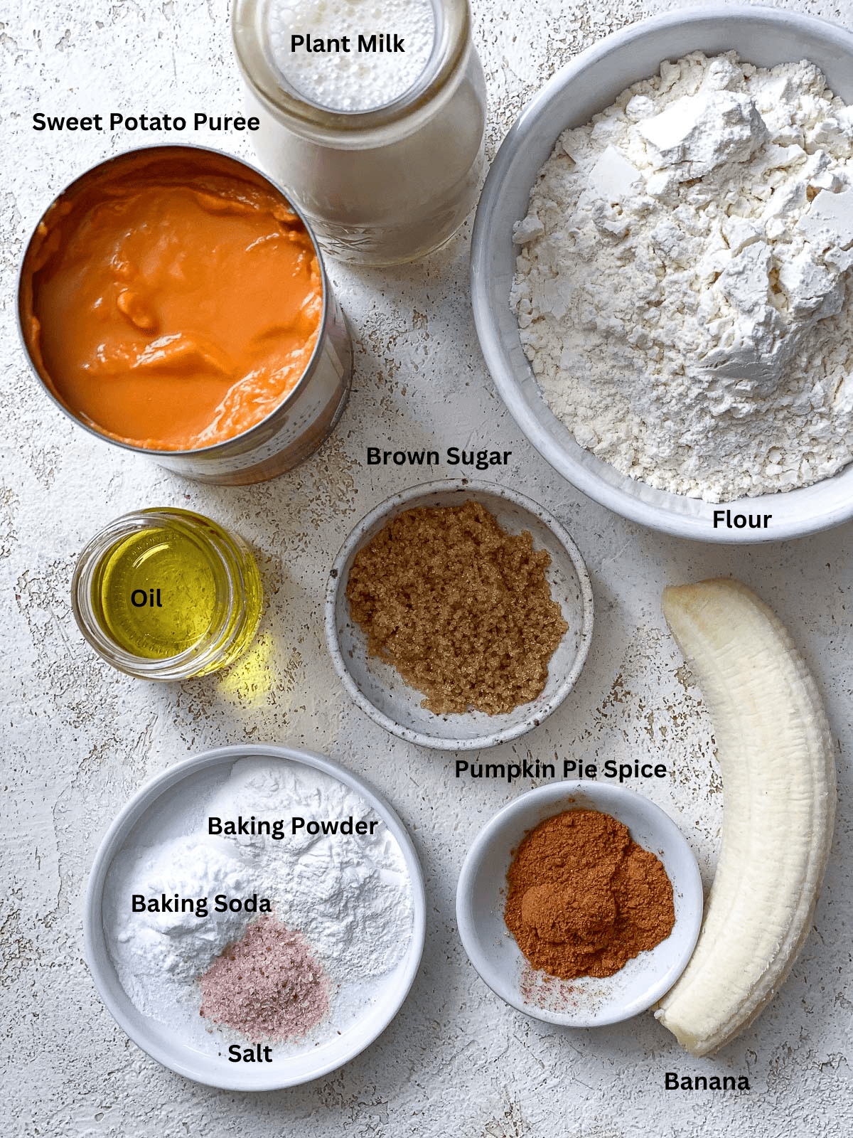 ingredients for Easy Sweet Potato Pancakes (Vegan) measured out on a white surface