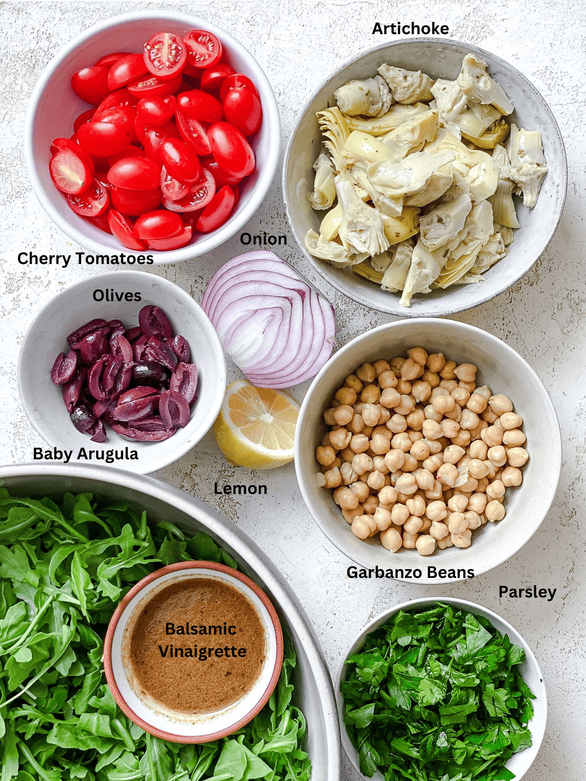ingredients for Quick and Easy Artichoke Salad on a white surface
