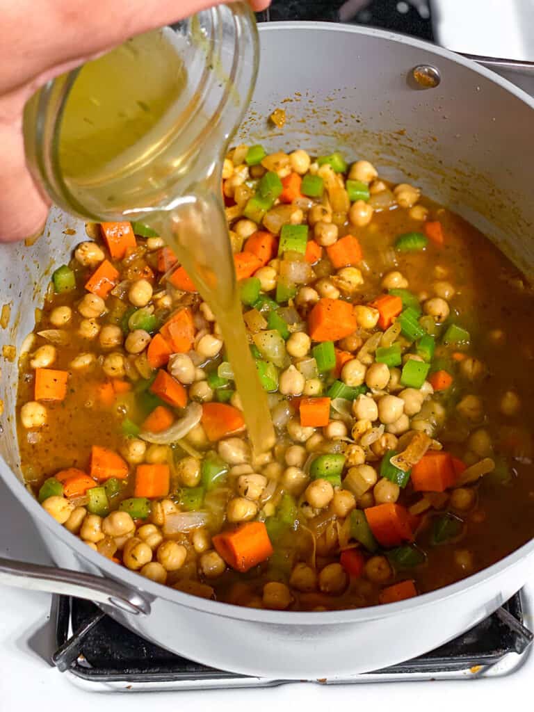 process shot of pouring broth in pot