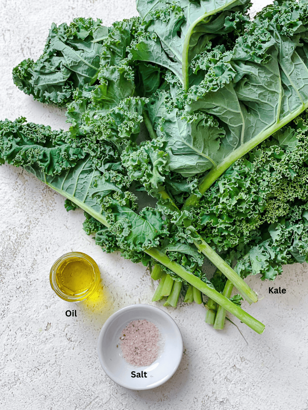 ingredients for Crispy Baked Kale Chips [+ Air Fryer Method] on a white surface