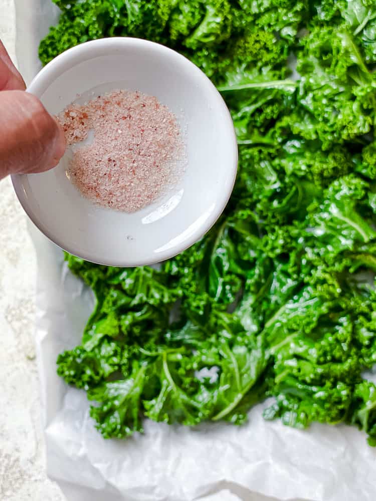 process shot of adding salt to kale
