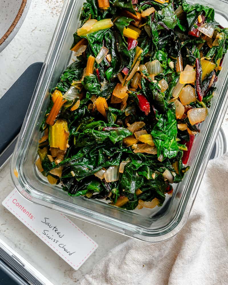 completed Sautéed Swiss Chard [with Garlic] in a storage container