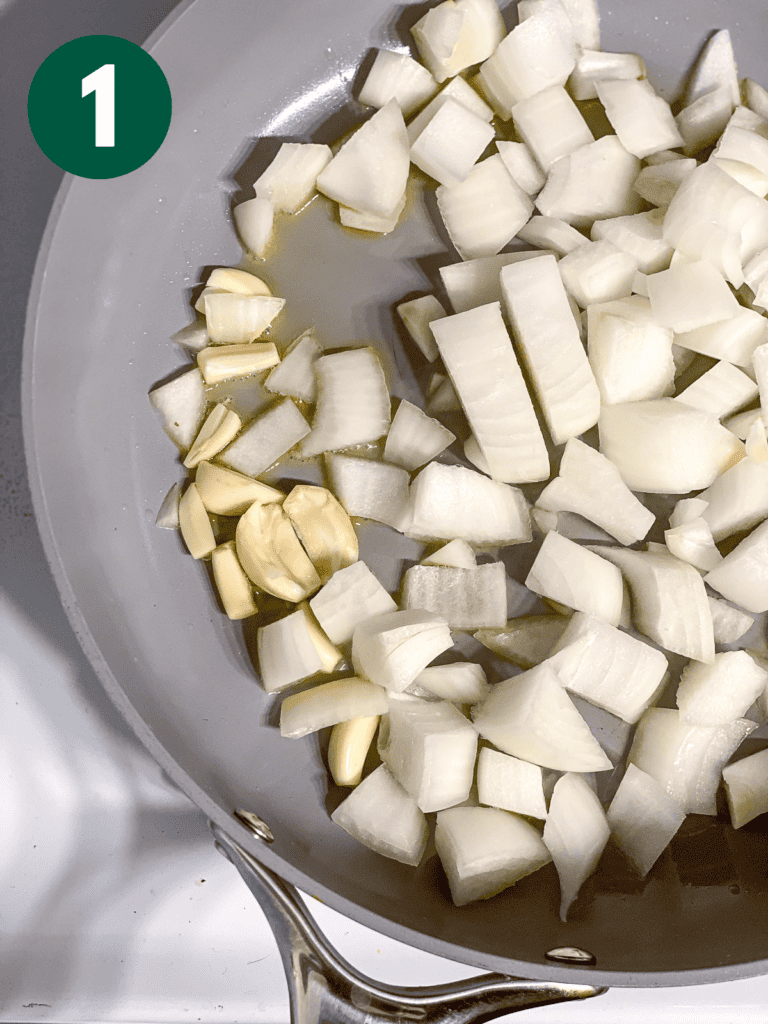 process s،t of cooking onion and garlic in a pan