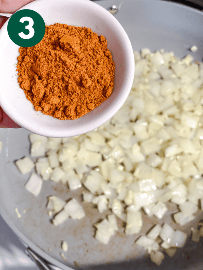 process shot of adding curry powder to pan