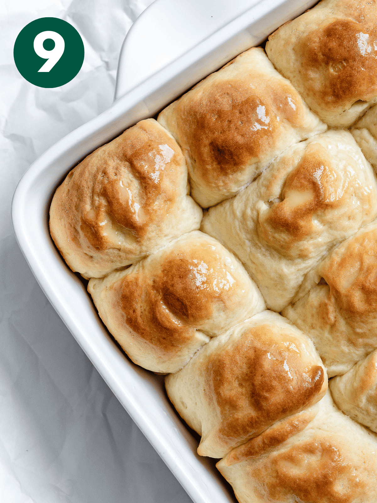 completed Easy Vegan Dinner Rolls on a white baking dish a،nst a white background