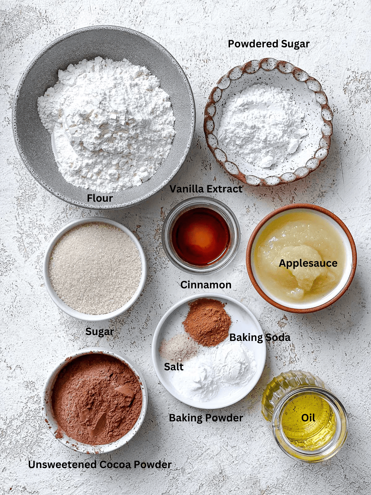 ingredients for Vegan Chocolate Crinkle Cookies on a white surface