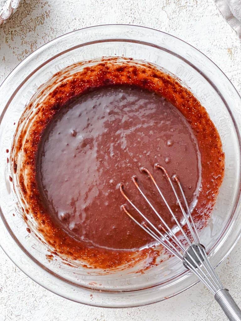 process shot of mixing ingredients together in a bowl