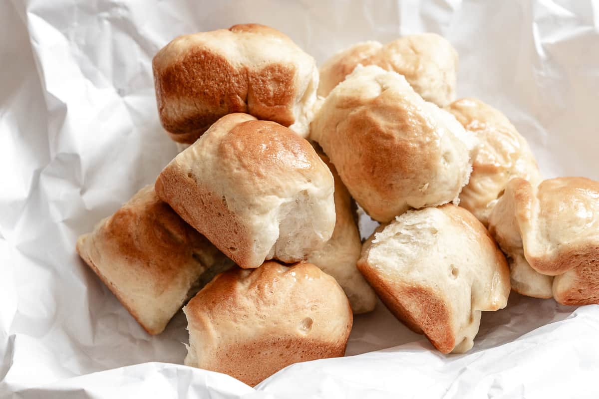 completed Easy Vegan Dinner Rolls on a white baking dish against a white background