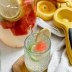 Completed Cucumber Lemonade in glass and pitcher.