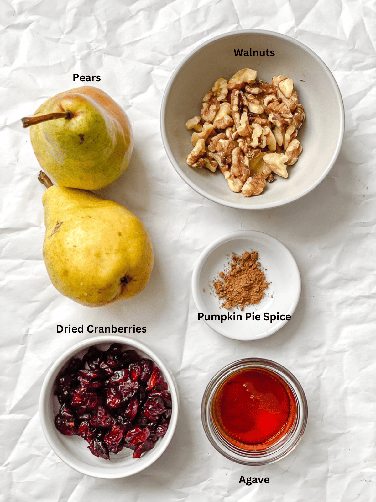 ingredients for Easy Baked Pears [Stuffed with Nuts and Fruit] on a white surface