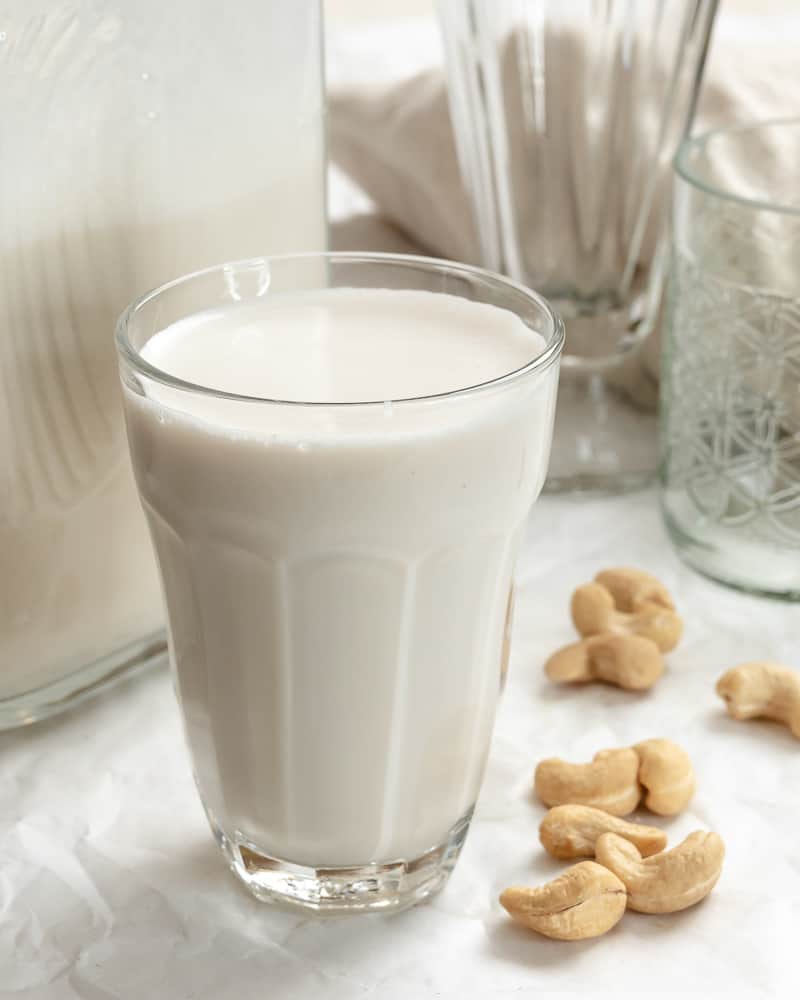 completed Cashew Milk in a gl، and jug