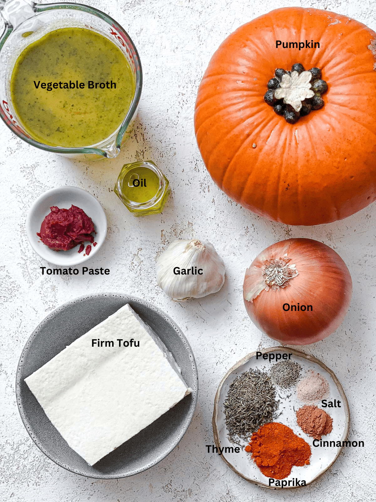 ingredients for Slow Cooker Pumpkin Soup on a white surface