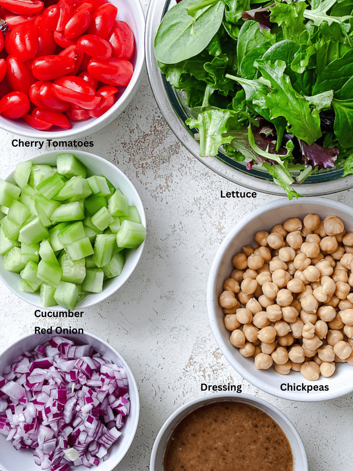 ingredients for Quinoa Chickpea Salad [In A Jar] measured out against a white surface