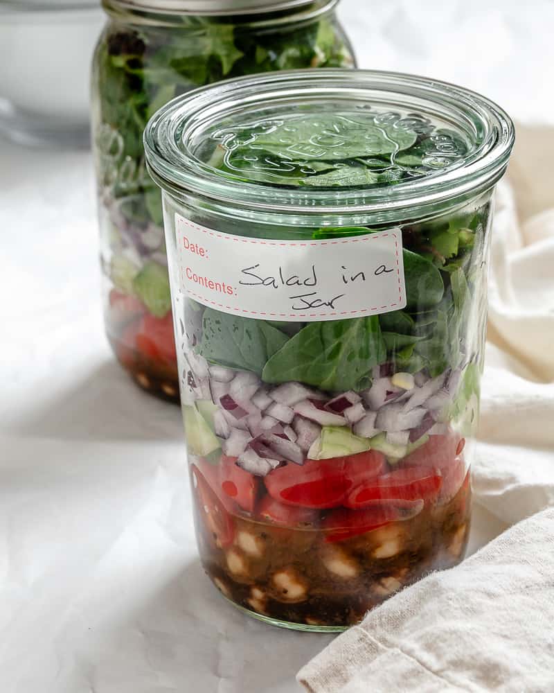 completed Quinoa Chickpea Salad [In A Jar] against a white background