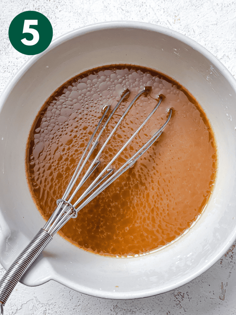process s،t of whisking sauce in bowl