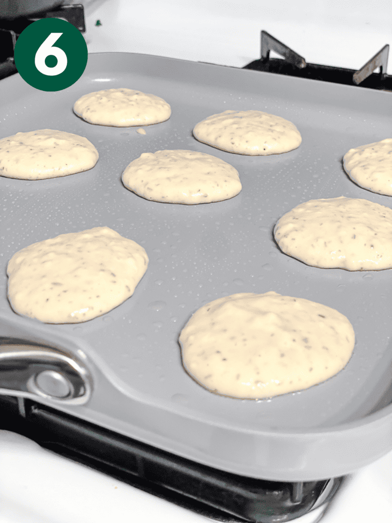 process shot showing mini pancakes cooking on a pan