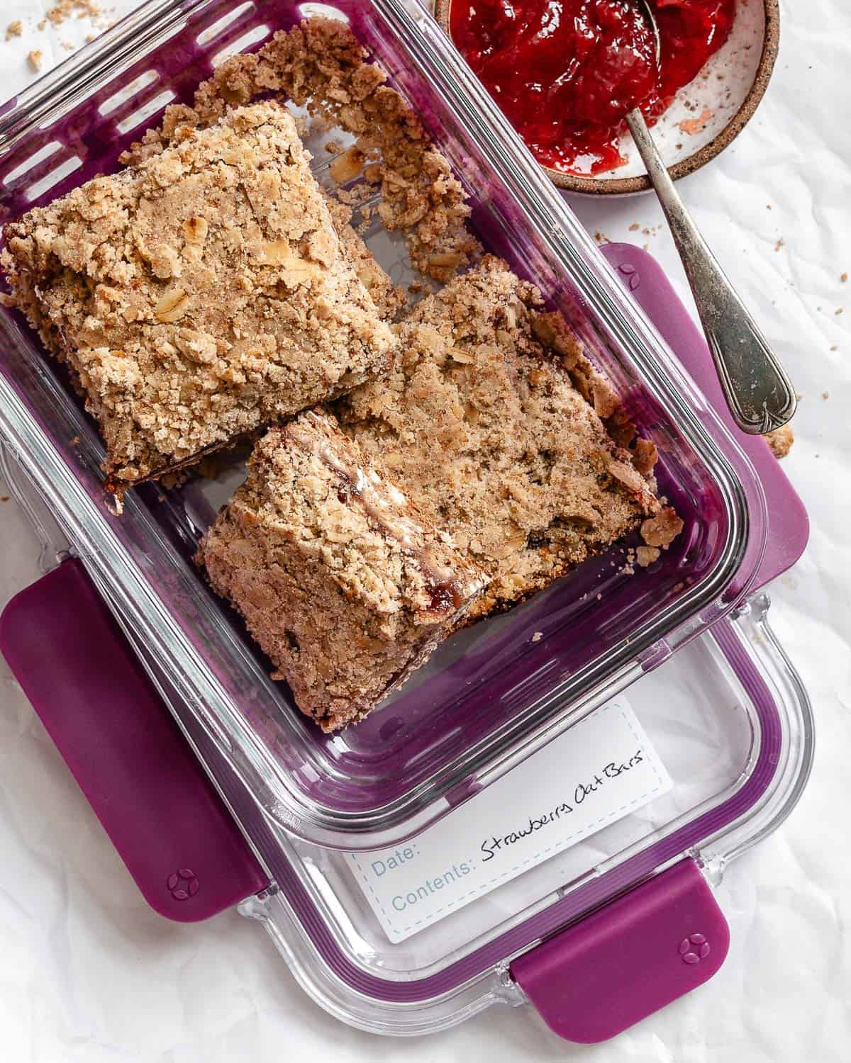 completed Easy Strawberry Oatmeal Bars in a storage container