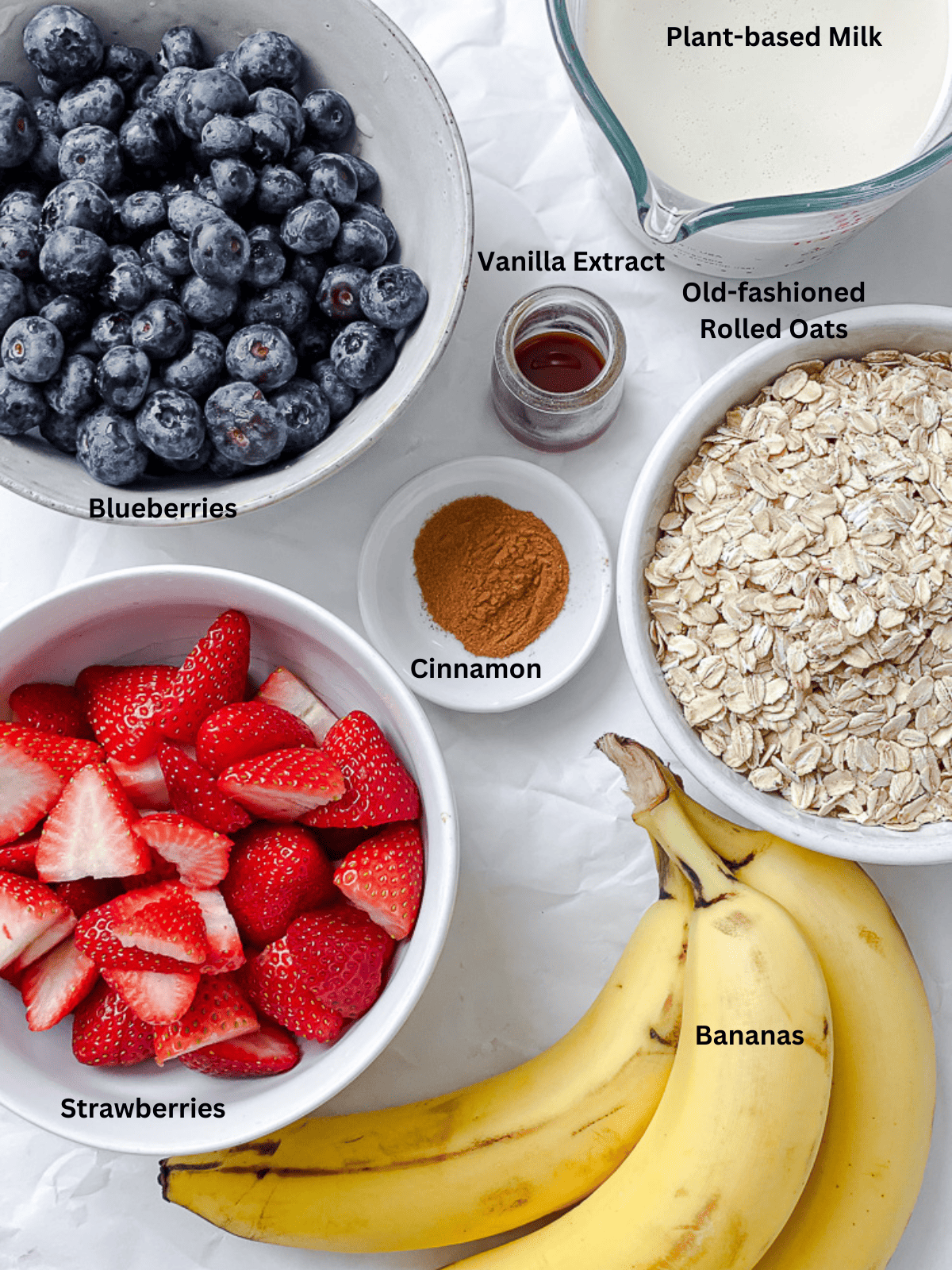 ingredients for Vegan Baked Oatmeal [With Berries] measured out on a white surface