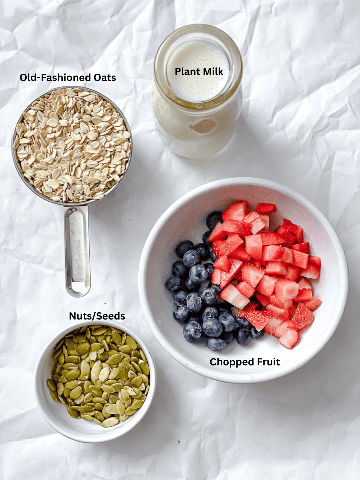 ingredients for Vegan Overnight Oats [Multiple Ways] measured out on a white surface
