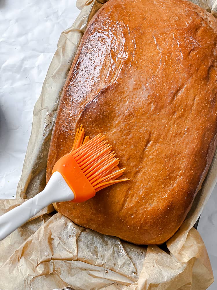 process shot showing oil being brushed onto loaf