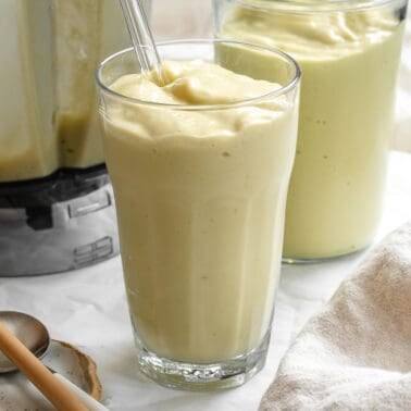 two glasses of completed Mango Avocado Smoothies