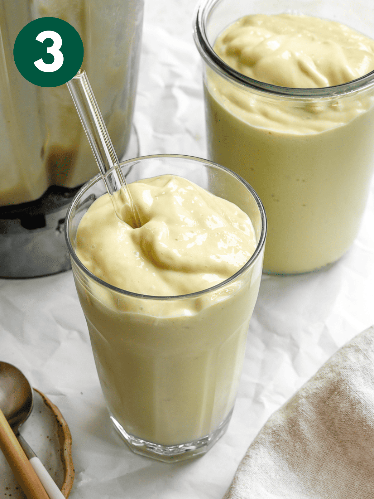 two glasses of completed Mango Avocado Smoothies