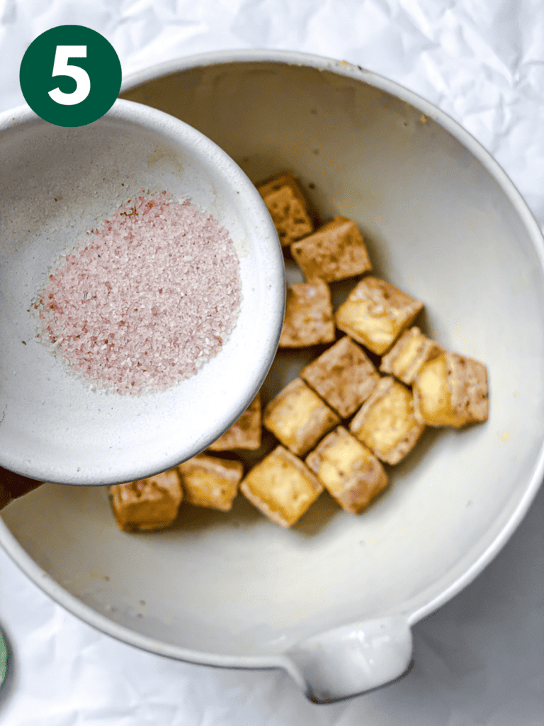 process s،t s،wing salt being added to tofu in bowl