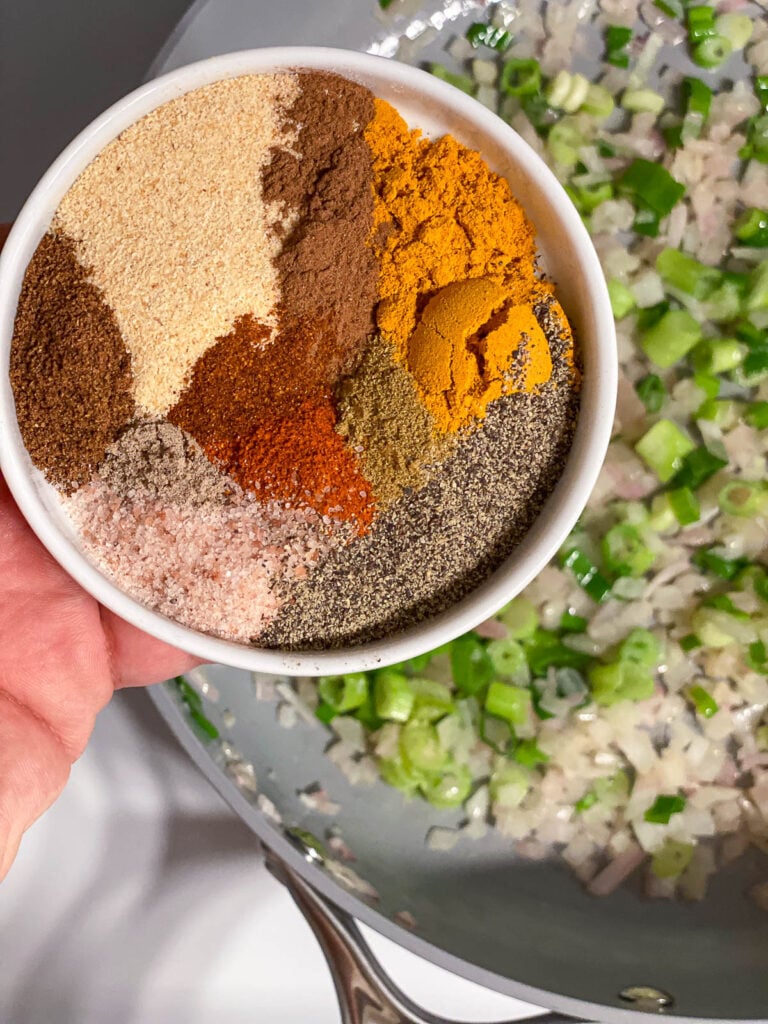 process shot showing spices being added to pan
