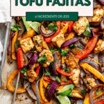 pinterest image of roasted taco-seasoned tofu chunks, onion, and bell peppers on a parchment-lined sheet pan.