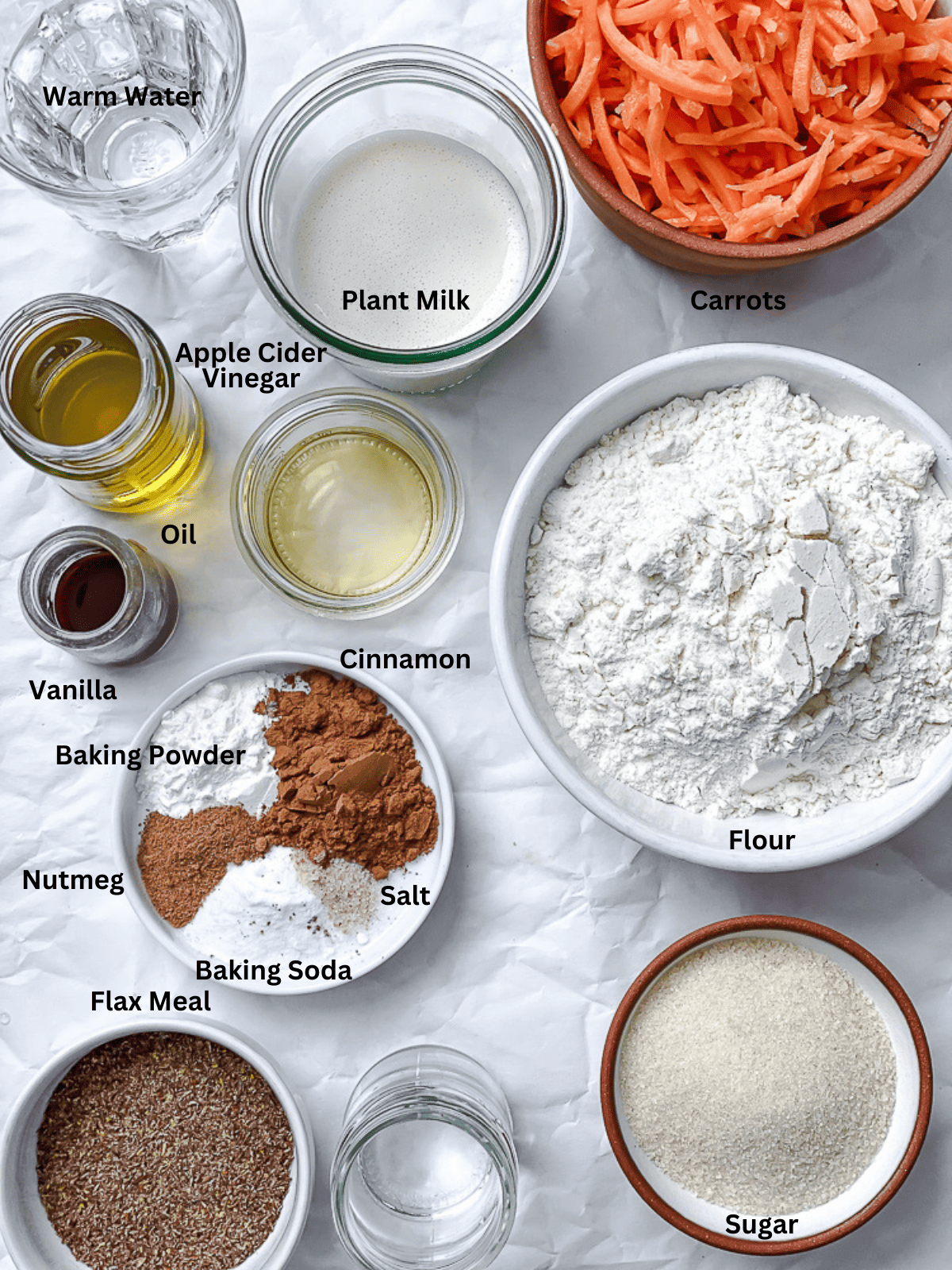 ingredients for Vegan Carrot Cake on a white surface