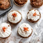 several completed Easy Carrot Cupcakes on a white surface