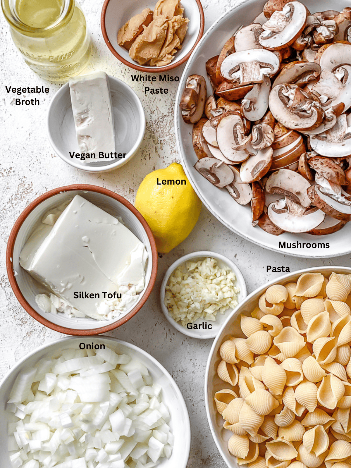 ingredients for Creamy Vegan Mushroom Pasta measured on a white surface