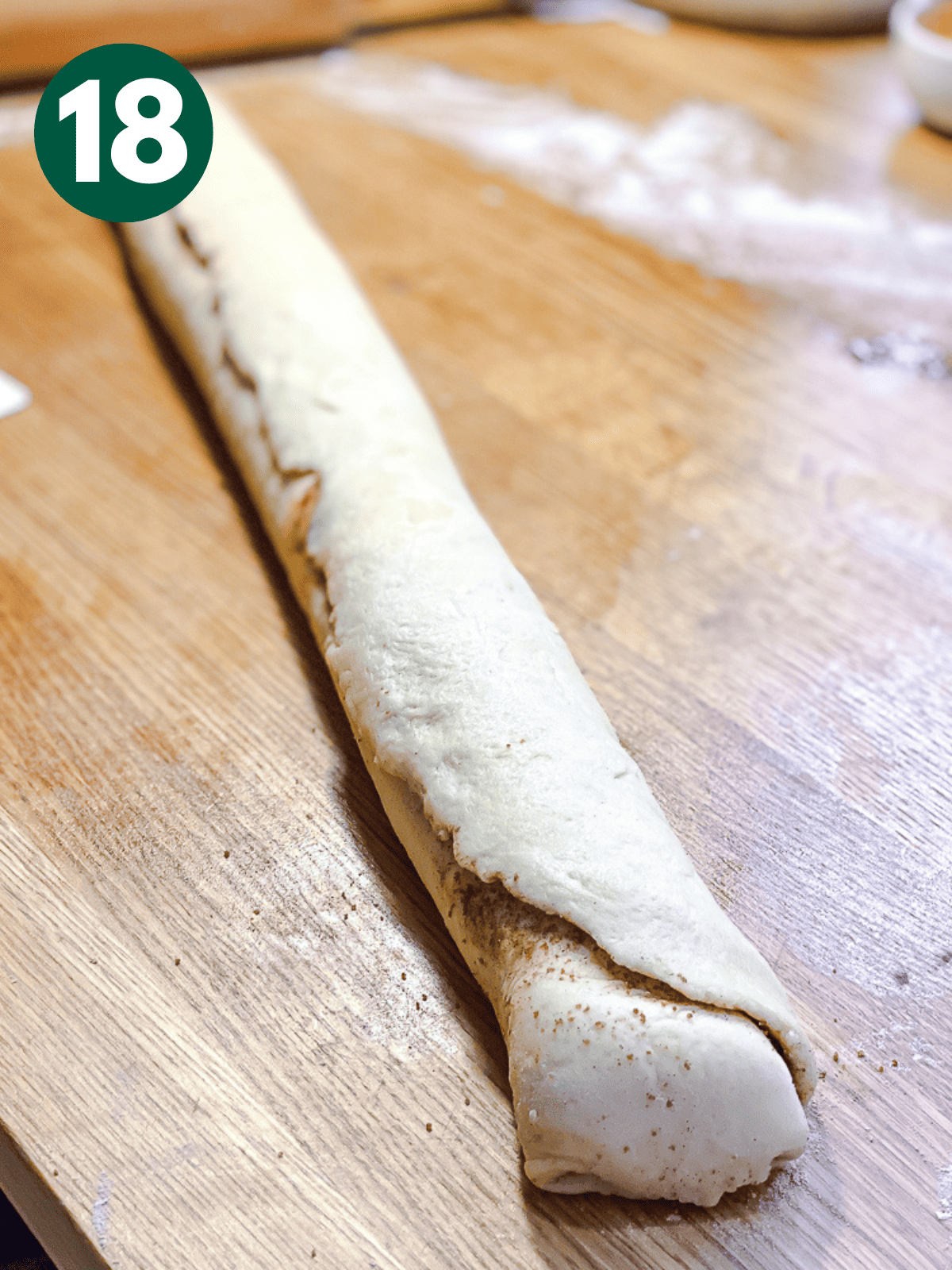 a log of cinnamon roll dough.